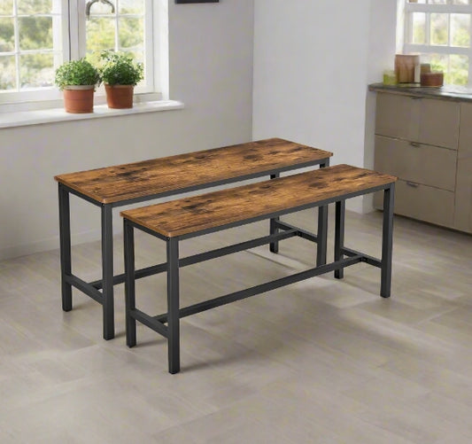Rustic brown wooden benches with black metal frames styled under a modern dining table