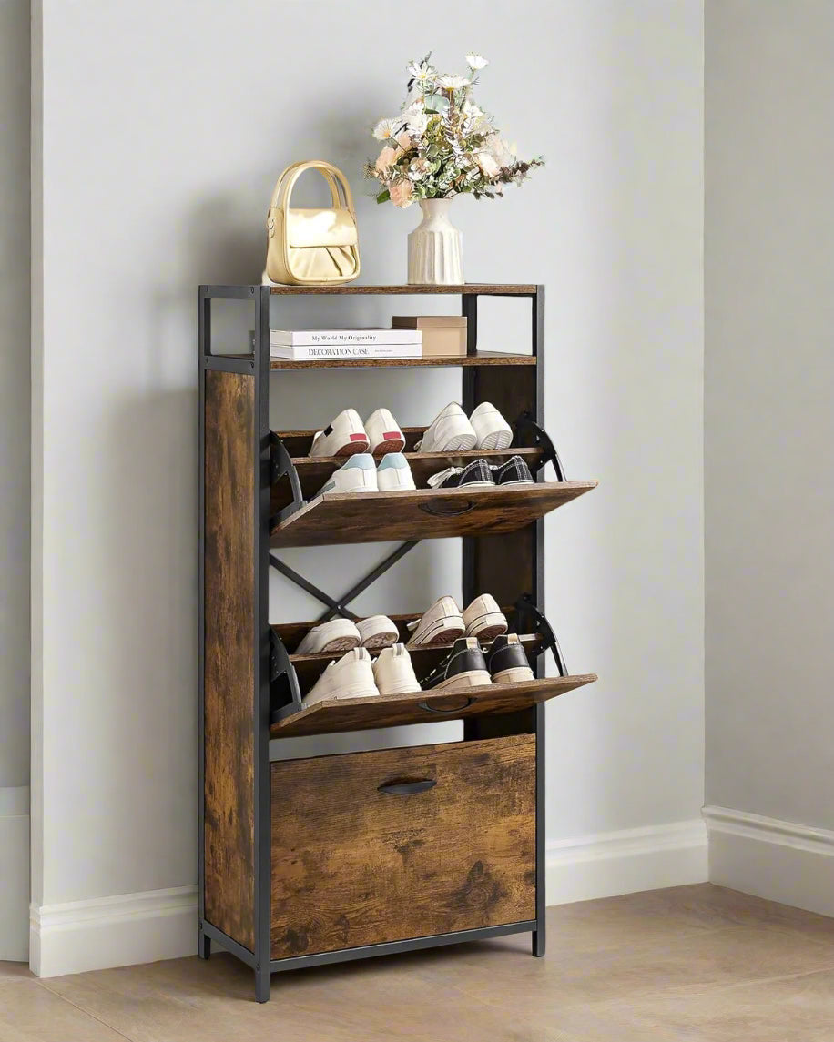 Wooden shoe rack with multiple shelves holding shoes against a light gray wall.