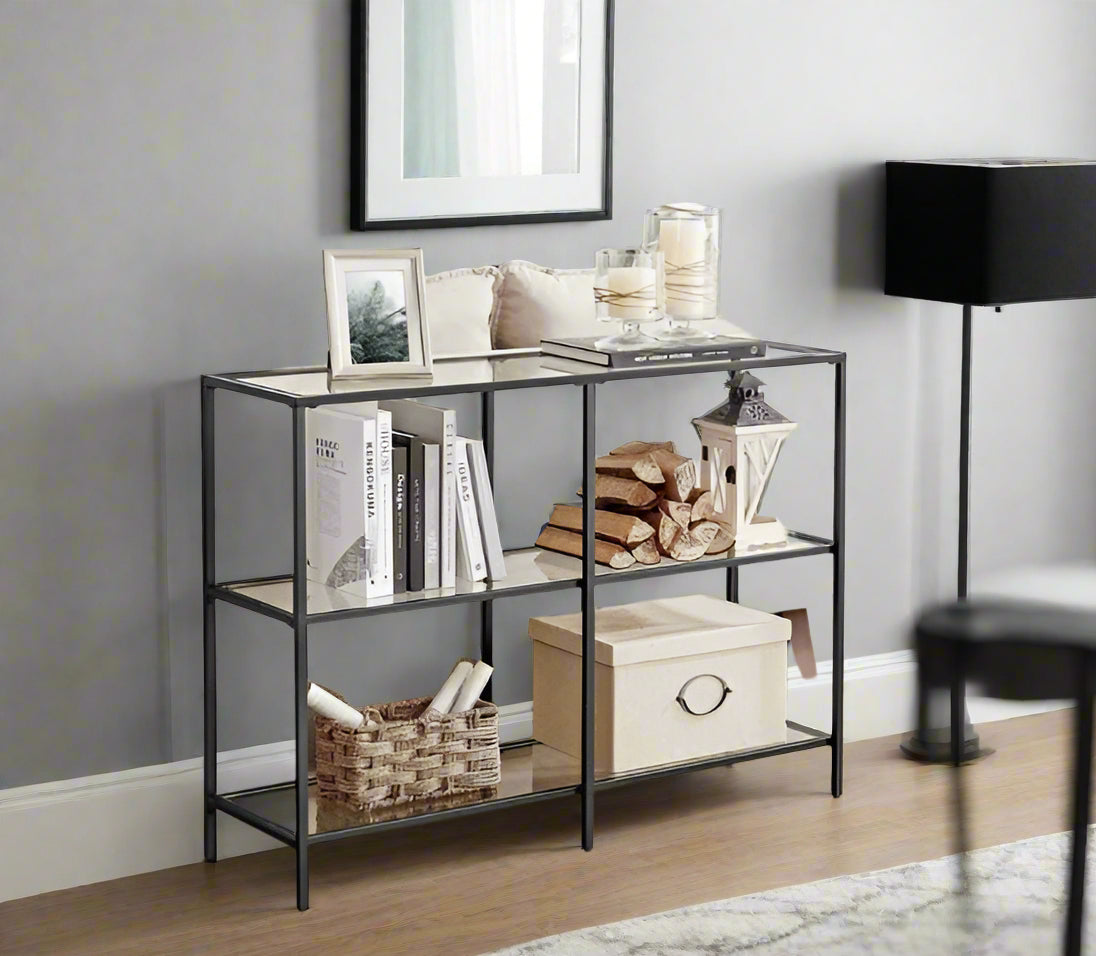 Modern 3-tier black steel console table with clear tempered glass shelves in stylish living room