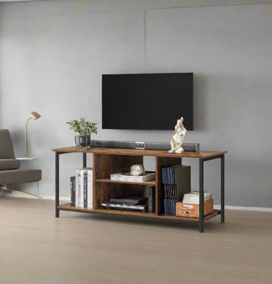 Wooden TV stand with electronic devices against a gray wall