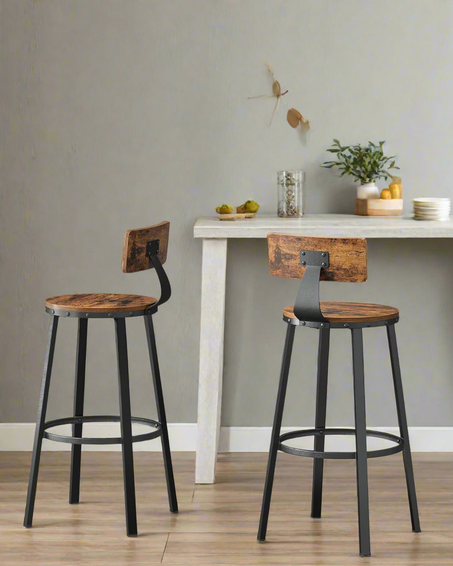 Set of 2 rustic industrial bar stools with black steel frame, curved backrests, and circular footrests