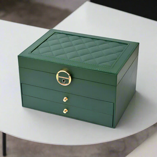 Green jewelry box with gold accents on a white surface