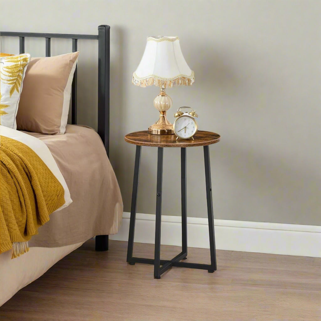 Round rustic brown and black industrial side table with metal X-frame legs, compact size for living room, bedroom, or hallway