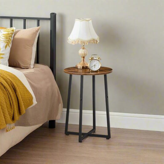 Round rustic brown and black industrial side table with metal X-frame legs, compact size for living room, bedroom, or hallway