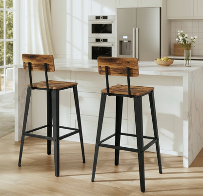 Two wooden bar stools with black legs in a kitchen setting.